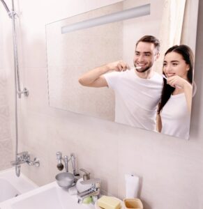 young-happy-couple-brushing-teeth-bathroom